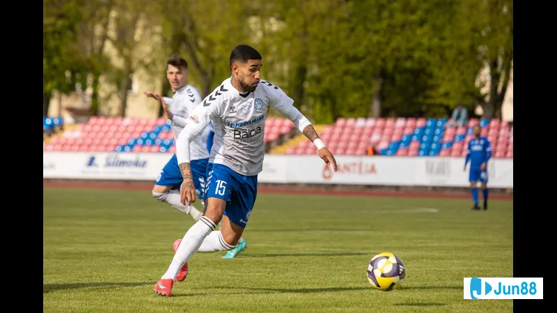 Hegelmann player dribbling past Dziugas Telsiai defenders Hegelmann player dribbling past Dziugas Telsiai defenders